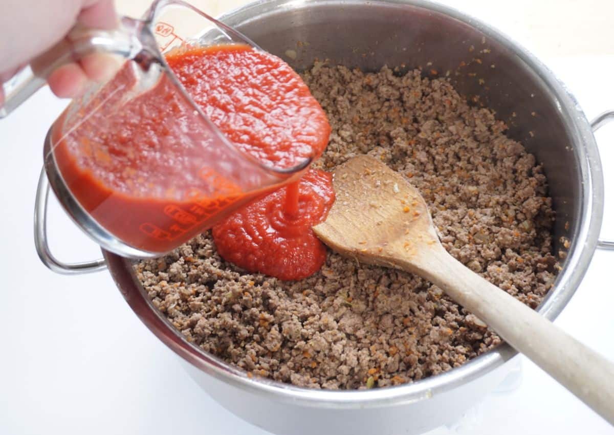 Ground beef and ground pork adding canned tomatoes